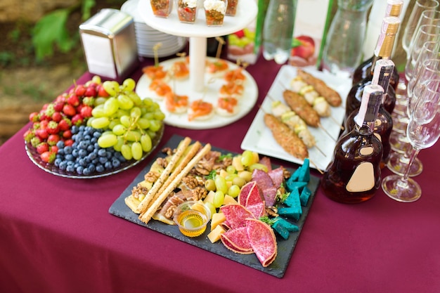 Cold snacks and fruits on the catering table