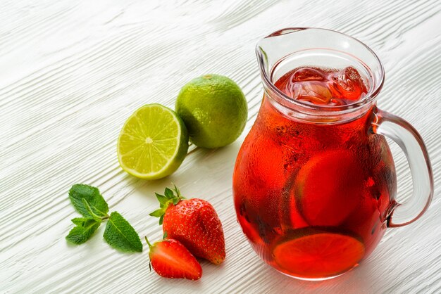 Cold strawberry drink with strawberry slices and mint.