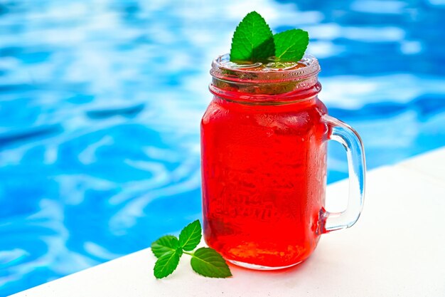 Cold strawberry lemonade in mason jar isolated