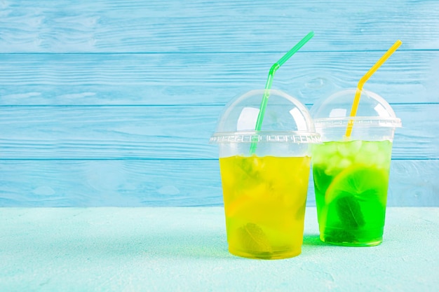 Cold summer lemonade with ice lemon and mint Cocktail to go