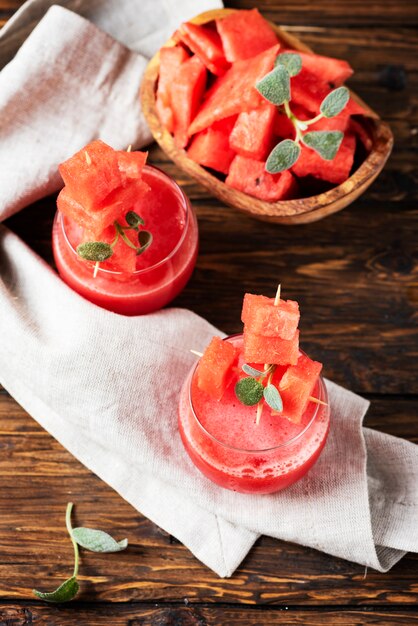 Cold watermelon juice with sage on the wooden table