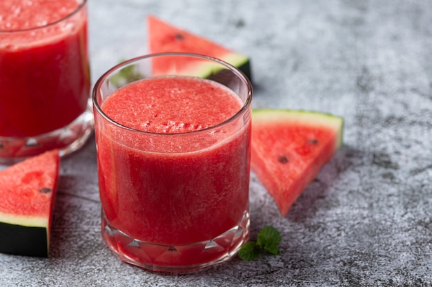 Cold watermelon smoothie on dark background