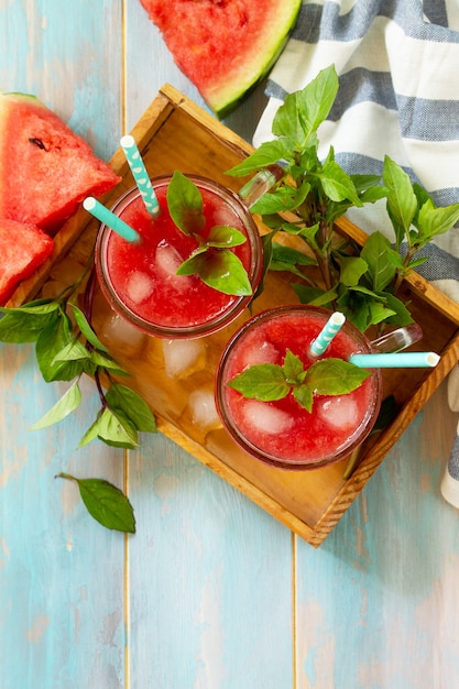 Cold watermelon smoothie summer watermelon drink in glasses and slices of watermelon