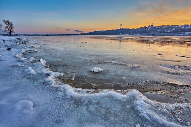 Cold Winter night cityscape with illuminated buildings in Kiev Ukraine