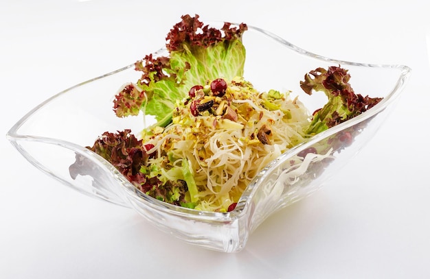 Coleslaw with pistachios in a glass bowl
