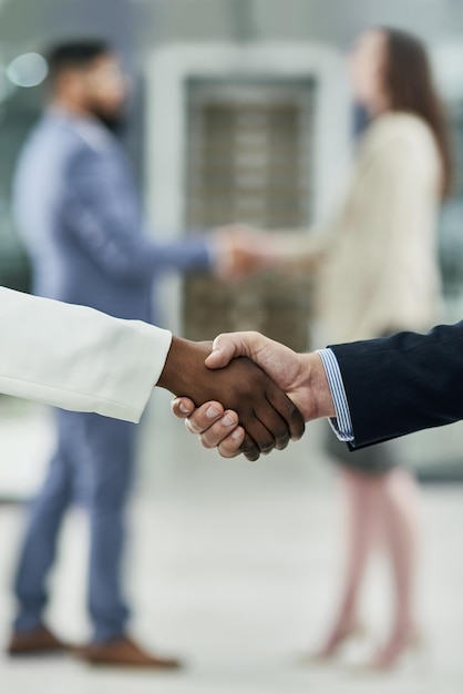 Collaborative spirits Cropped shot of two unrecognizable businesspeople shaking hands in a corporate office
