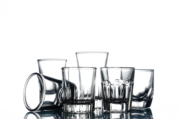 Collage of empty glasses on white background.