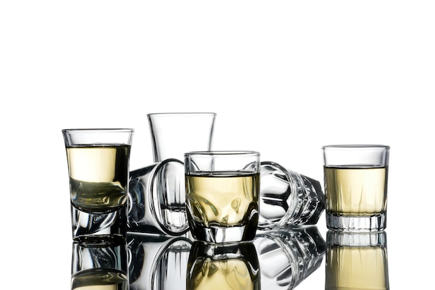 Collage of glasses with alcohol on a white background.