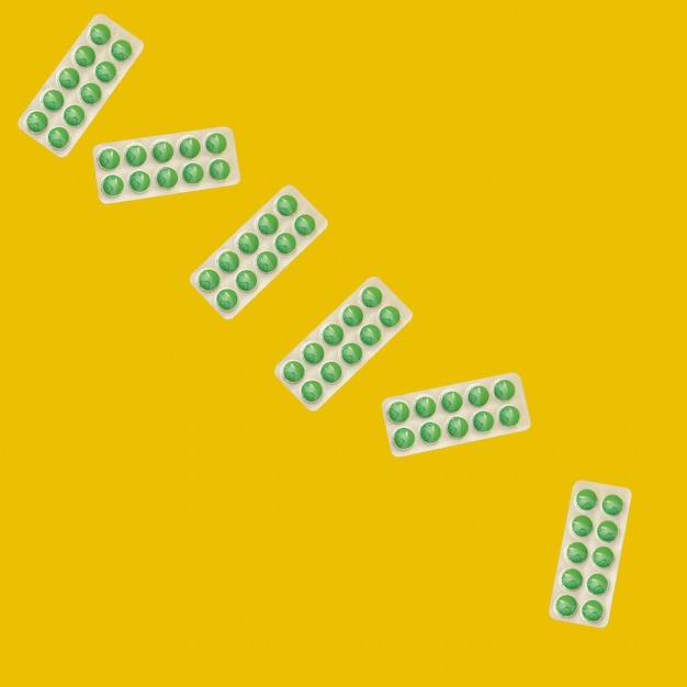 A collage of green pills on a yellow background