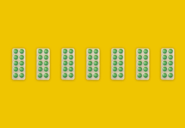 A collage with a green pill on a bright yellow background