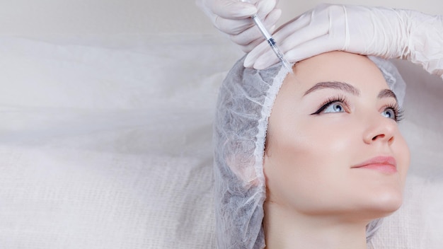 Collagen Rejuvenating facial injections procedure on the face skin in a beauty salon