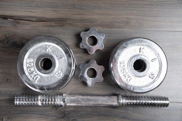 Collapsible dumbbell on a wooden table