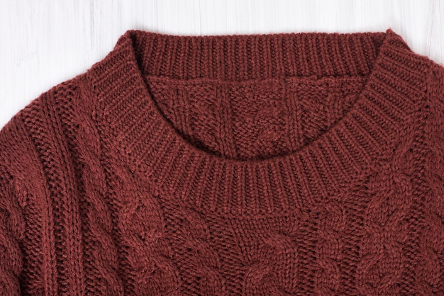 Collar brown knitted sweater. Close up. Fashion concept