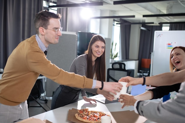 Colleagues celebrate the successful start of a business project in the office