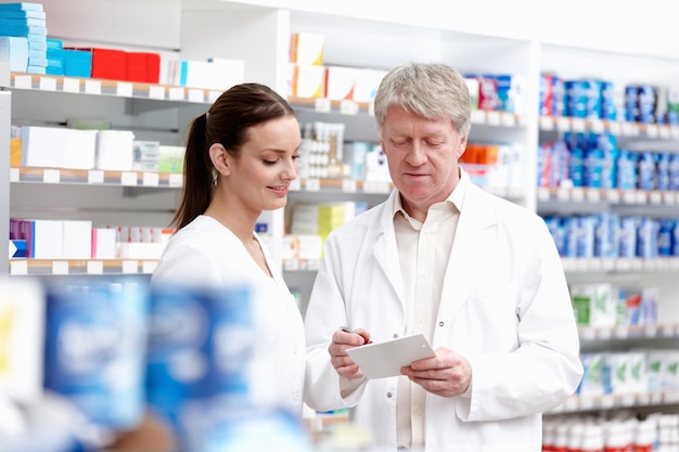 Colleagues checking the medicine Portrait of medical colleagues checking the medical prescription at store