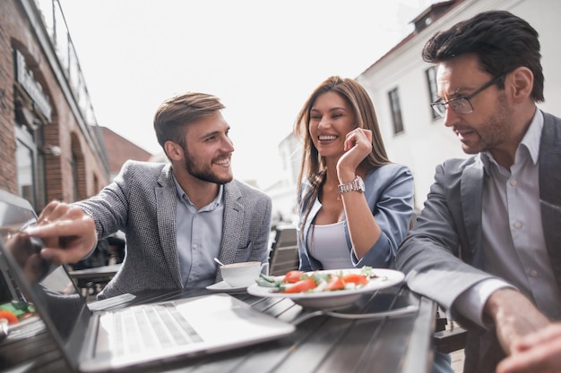 Colleagues discuss new information at a table in a cafethe concept of teamwork