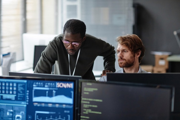 Colleagues discussing work issues over computer