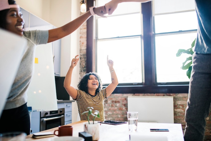 Photo colleagues doing a fist bump in the office