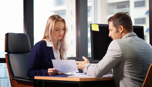 Colleagues doing paperwork in office