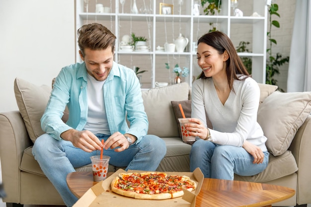 Colleagues eat pizza and chat a snack break in the office