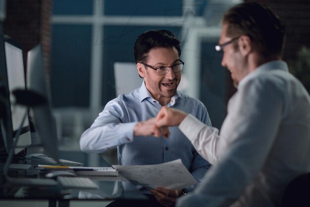 Colleagues give each other a fist The coworking and teamwork