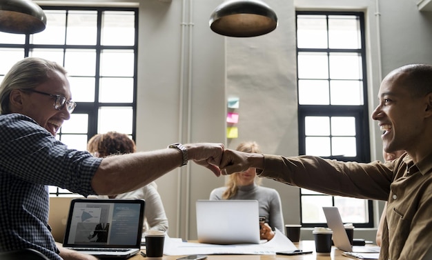 Photo colleagues giving fist bump in agreement