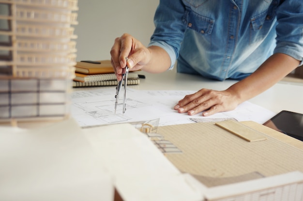 Colleagues interior designer corporate achievement planning design on blueprint