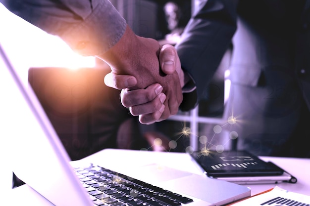 Colleagues shaking hands in office