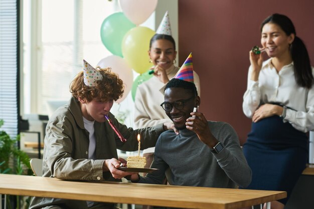 Photo colleagues taking birthday selfie