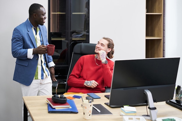 Colleagues talking together at office