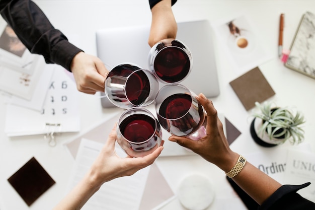 Colleagues toasting wine glasses at work