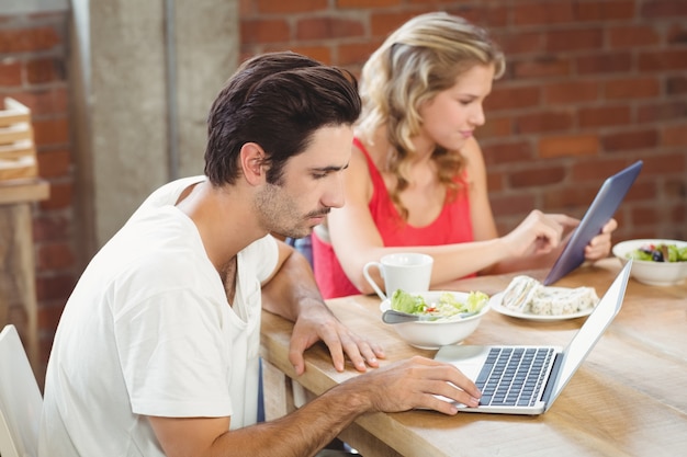 Colleagues using technologies in office