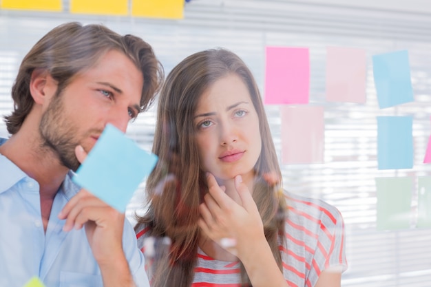 Colleagues watching sticky notes