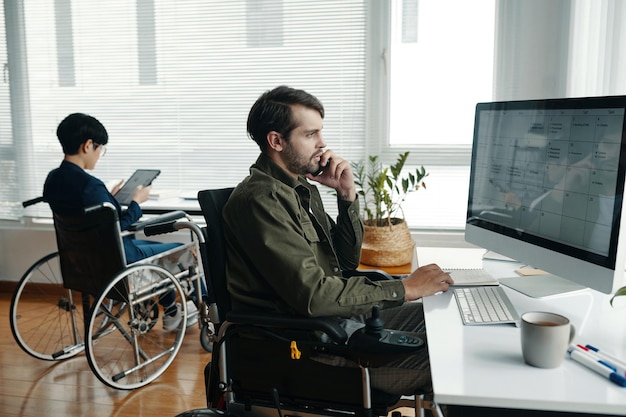 Colleagues With Disability Working In Office