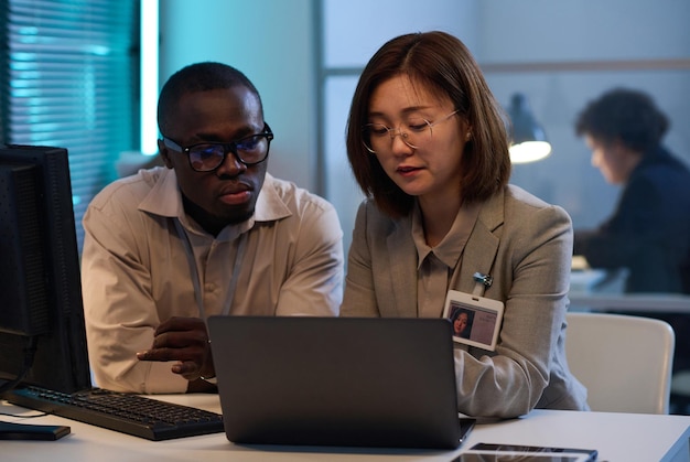 Colleagues working on computer in team