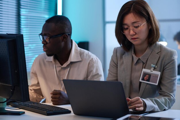 Colleagues working on computers in office