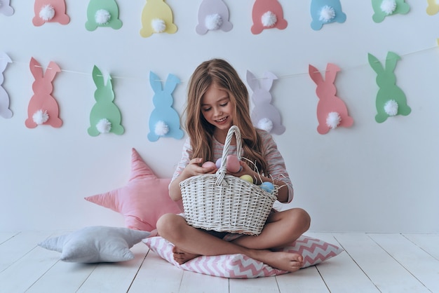 collecting easter eggs.  cute little girl holding easter eggs and smiling 