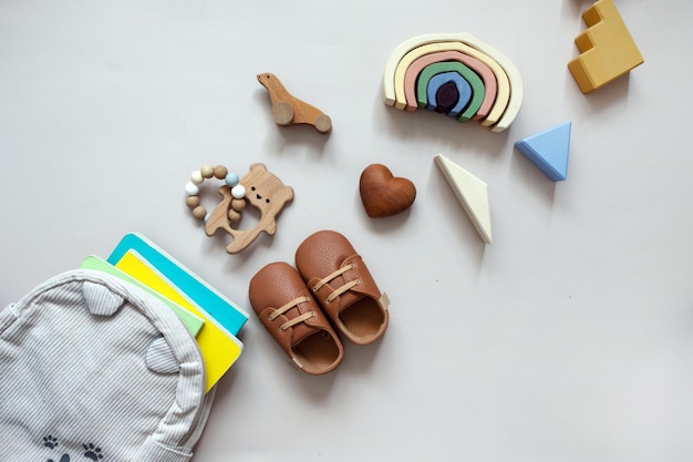 A collection of baby toys including a baby bootie and a diaper bag.