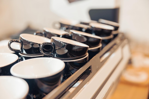 Collection of black coffee cups in cafeteria or coffee shop