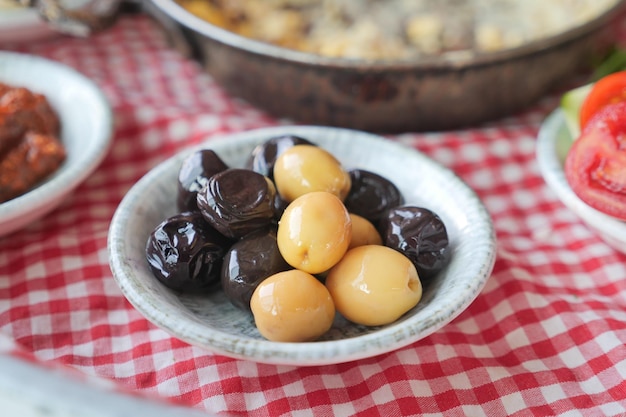 Collection of black and green olives with leaves