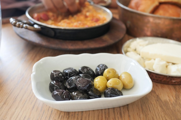 Collection of black and green olives with leaves