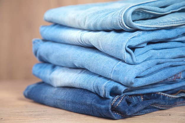 Collection of blue jeans on table