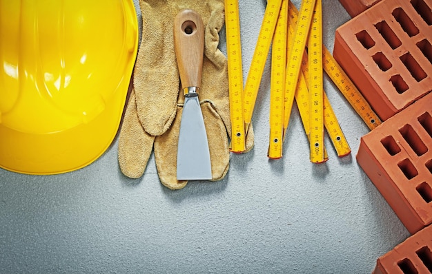 Collection of bricklaying tools on concrete background construction concept.