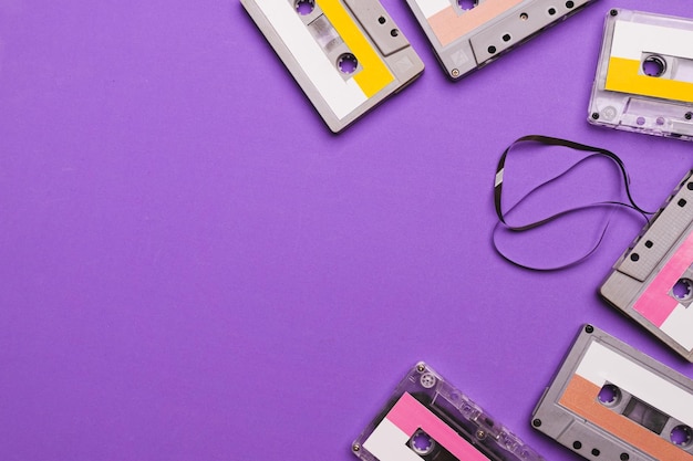 Collection of cassette tapes on purple background copy space fot text