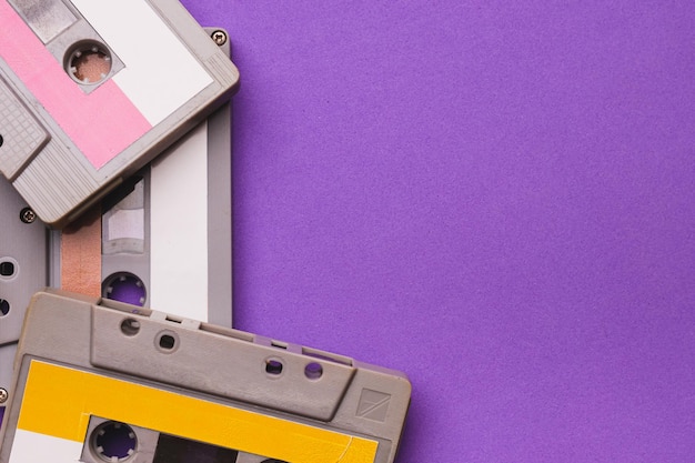 Collection of cassette tapes on purple background copy space fot text