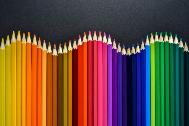 Photo collection of colored pencils on black background