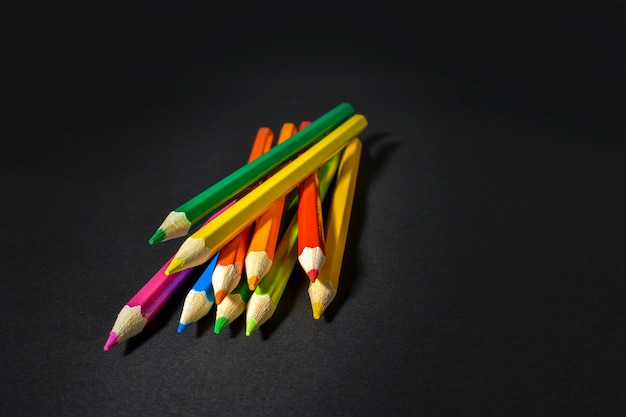 Collection of colored pencils on black background