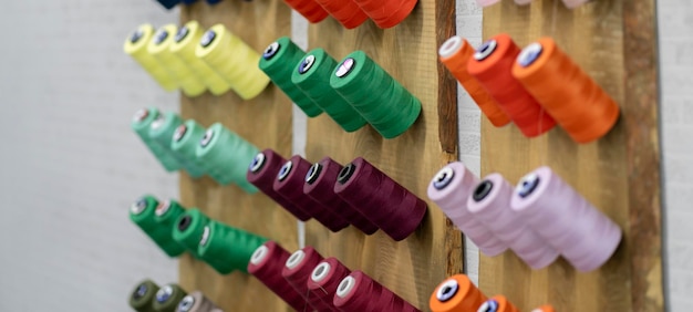 collection of colorful thread rolls on sewing manufacture