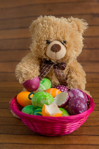 Collection of easter eggs in basket and soft toy