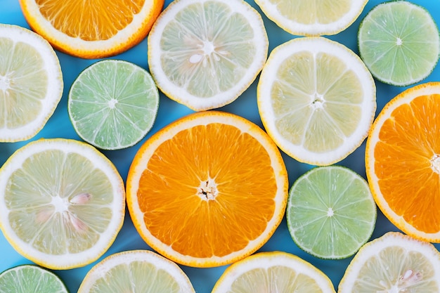 Collection of fresh lime lemon orange citrus grapefruit slice on blue background